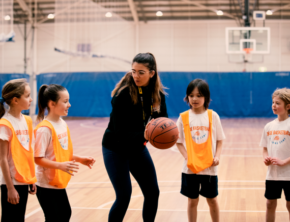 women-coaching-girls-chase-basketball